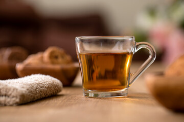 Organic Lemon Green tea in Transparent cup at table near window