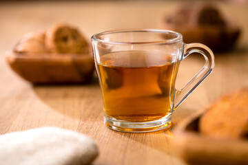 Organic Lemon Green tea in Transparent cup at table near window