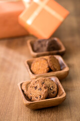 wooden tray with many different types of cookies on wooden background.