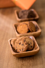 wooden tray with many different types of cookies on wooden background.