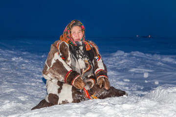 A woman with her daughter, in the national winter clothes of the northern inhabitants of the...