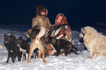 A woman with her daughter, in the national winter clothes of the northern inhabitants of the...