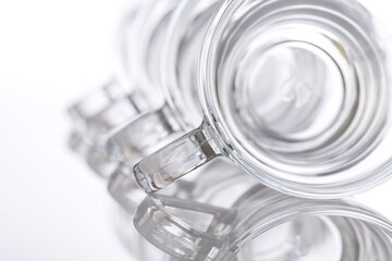 Empty glass tea cups arranged on white background