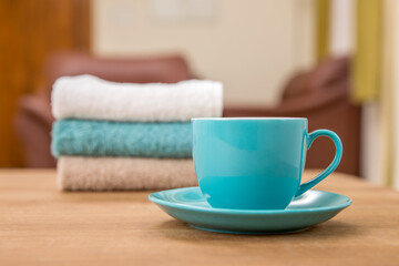 Tea cup with hand towel on table.