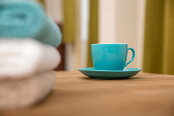 Tea cup with hand towel on table.