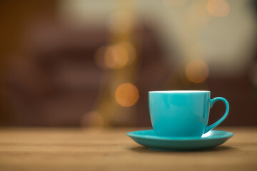 Teal tea cups on table at home.