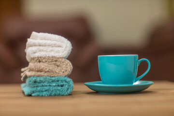Tea cup with hand towel on table.