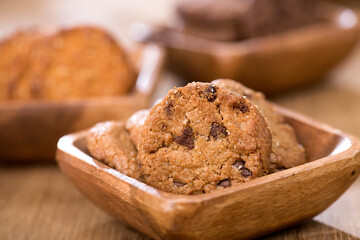 wooden tray with many different types of cookies on wooden background.
