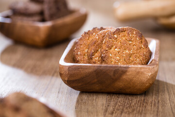 wooden tray with many different types of cookies on wooden background.