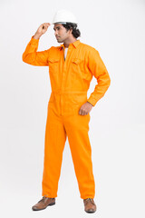 Indian municipal young worker standing with safety helmet on white background.