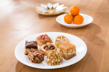 Plates of Oriental sweets on table.