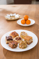 Plates of Oriental sweets on table.