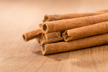 cinnamon sticks on wooden table.