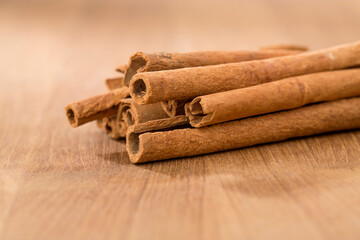 cinnamon sticks on wooden table.
