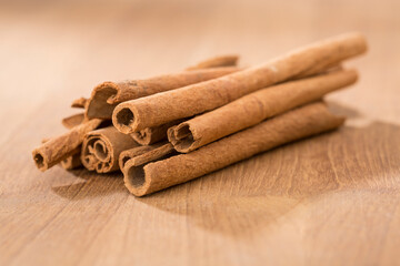 cinnamon sticks on wooden table.