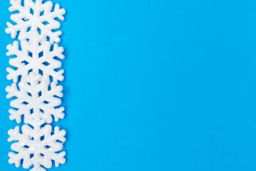 winter flat lay with snowflakes on blue