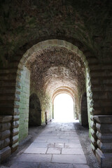 Enfilade of old stone arch in ruined medieval castle