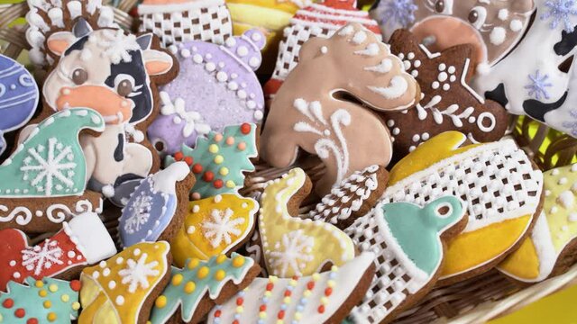 Christmas gingerbread in a basket with shape of new year trre, bull, snowflake, bell, deer, angel rotates on the table,close up.