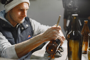 Hand worker with empty bottle. Man's hand close-up.The concept of production.