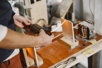 Hand worker with empty bottle. Man's hand close-up.The concept of production.