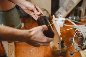 Hand worker with empty bottle. Man's hand close-up.The concept of production.