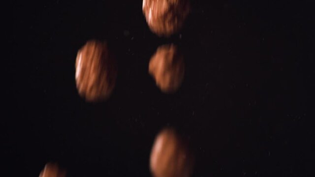 Chocolate flakes falling on a black background close up