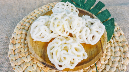 Kerupuk ikan putih is Indonesian traditional food served in wooden plate. Selective focus.