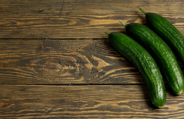 Fresh green cucumbers isolated on wooden background