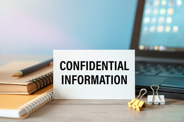 Confidential Information - the inscription on the card on the background of the keyboard