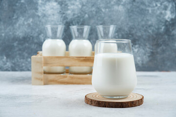 A glasses of milk on a gray background