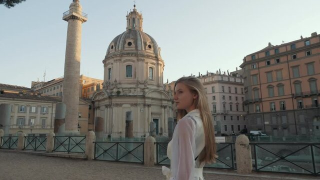 Young Tourist woman exploring European town at sunrise. Beautiful girl walking through street travelling enjoying summer vacation travel adventure near ruins Rome Italy