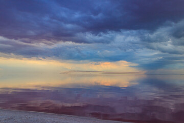 Dark storm clouds over a salt lake before a rain