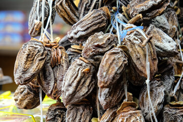 Dried figs, close-up at fair. Traditional delicious dessert, Caucasian cuisine. Unusual treat. Healthy food concept, vegetarianism, local product. Horizontal format
