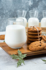 Glasses of milk with chocolate cookies and leaves