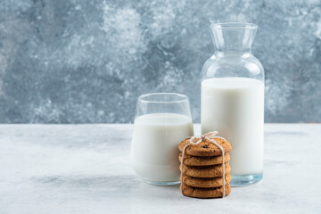 A glass and jar of milk with delicious cookies
