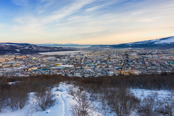View of the city of Magadan. Northern city on the coast of the Sea of ​​Okhotsk. Beautiful winter cityscape. Top view of the streets and buildings. Magadan, Magadan Region, Siberia, Far East of Russia