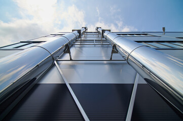 big steel pipes on a wall of plant