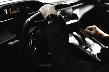 Businessman driving a sports luxury car.Hand on the handle. Close-up of man in formal attire opening car door