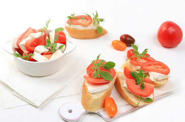 Caprese Bruschetta toast with mozzarella cheese, cherry tomatoes and fresh garden Basil.Traditional Italian food, healthy natural Breakfast, cholesterol-free and GMO-free, space for text,