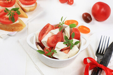 Caprese Bruschetta toast with mozzarella cheese, cherry tomatoes and fresh garden Basil.Traditional Italian food, healthy natural Breakfast, cholesterol-free and GMO-free, space for text,