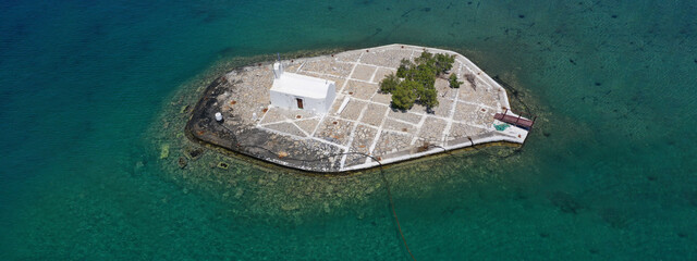 Aerial drone ultra wide photo of small chapel of Panagia Mirtidiotissa built on a small islet in...