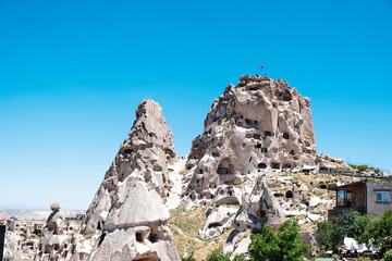 Fototapeta premium An ancient city in Cappadocia. Stone houses in the rocks. Famous castles in Cappadocia with selective focus.