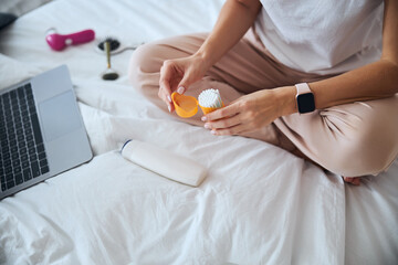 Stylish pretty lady holding q-tips in hand in room indoors