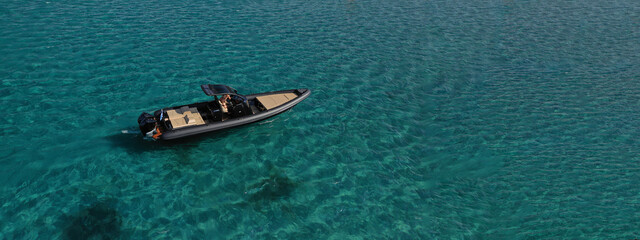 Aerial drone ultra wide photo of inflatable rib power boat anchored in tropical exotic emerald...