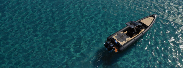 Aerial drone ultra wide photo of inflatable rib power boat anchored in tropical exotic emerald...