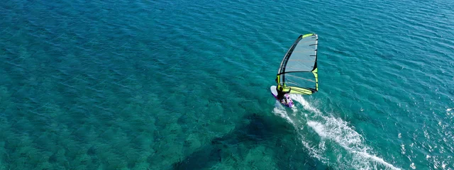  Aerial drone ultra wide photo of professional wind surfer practice in deep blue open ocean sea © aerial-drone