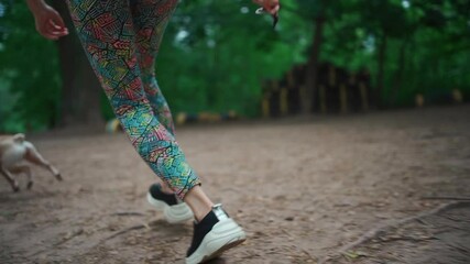 young female and french bulldog dog run or play with stick at playground outdoor