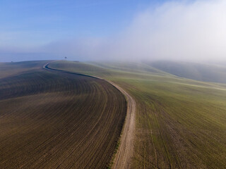 Road in the morning. Misty countryside day. Aerial view.