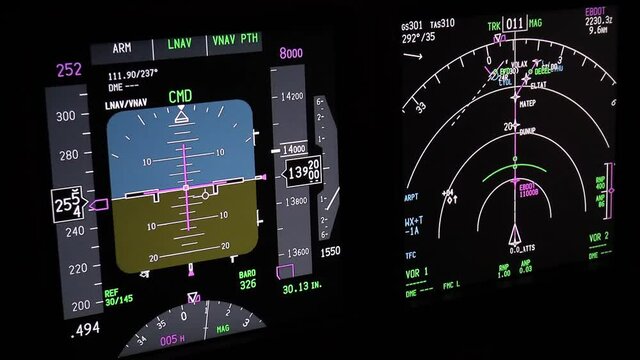 Flight instruments display of a modern passenger airplane flying at night. Actual cockpit footage. Aircraft is descending for landing.