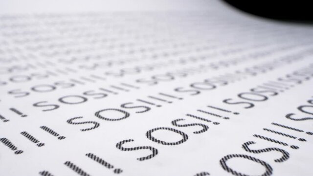 background text. extremely close-up, detailed. words sos printed in english letters on paper